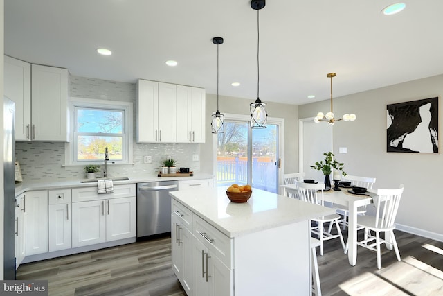 kitchen featuring white cabinets, a healthy amount of sunlight, stainless steel dishwasher, and sink