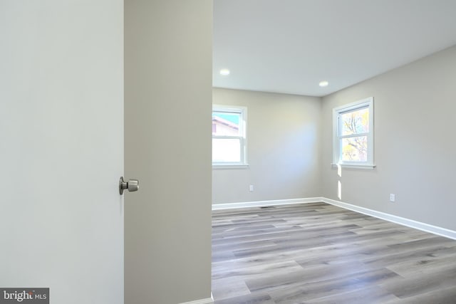 spare room with light hardwood / wood-style floors