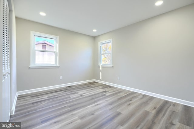 empty room with light hardwood / wood-style flooring