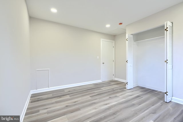 unfurnished bedroom with light hardwood / wood-style floors and a closet