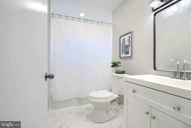 bathroom featuring toilet, vanity, and walk in shower