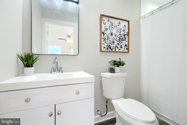 bathroom featuring toilet and vanity