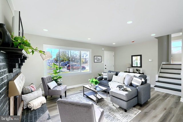 living room featuring a wealth of natural light and light hardwood / wood-style floors