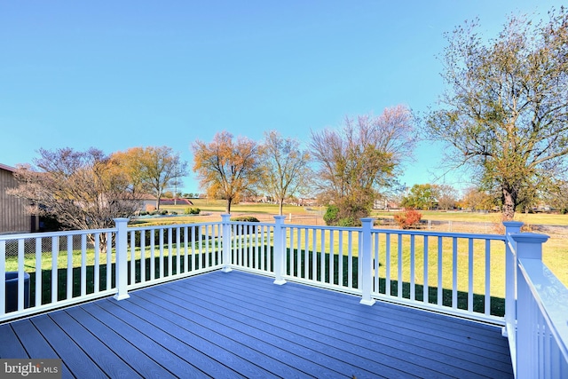 wooden terrace featuring a yard