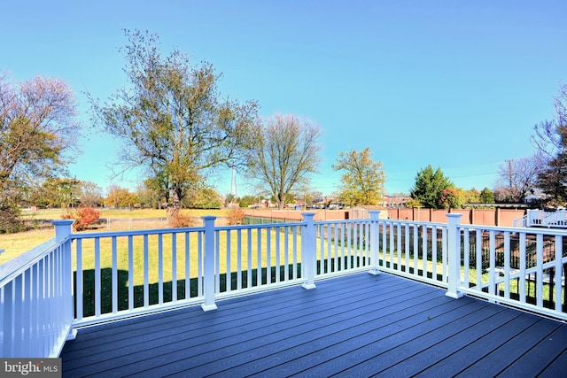 wooden terrace with a lawn