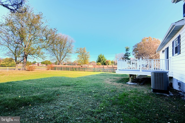 view of yard with a deck and central AC