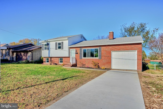 tri-level home with a garage and a front lawn