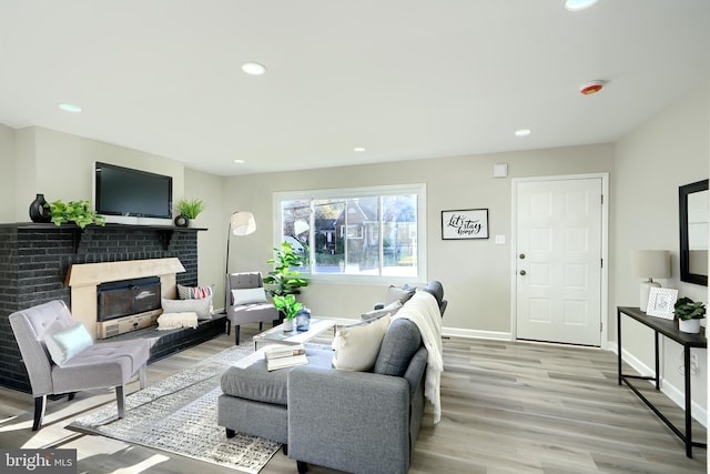 living room with a fireplace and light hardwood / wood-style flooring