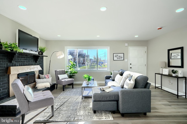 living room with a fireplace and light hardwood / wood-style floors