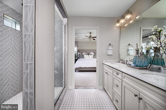 bathroom with vanity, a tile shower, and ceiling fan