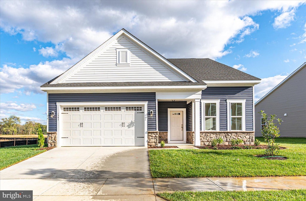 view of front of house with a front yard and a garage