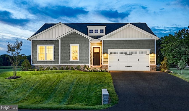 craftsman inspired home with a front yard and a garage