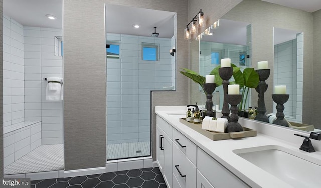 bathroom featuring vanity, tiled shower, and tile patterned flooring