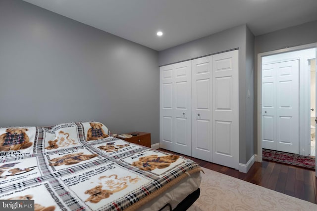 bedroom with a closet and dark hardwood / wood-style flooring