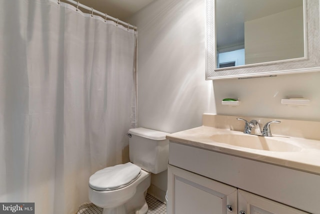 bathroom with tile patterned floors, vanity, and toilet