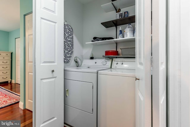 laundry area with dark hardwood / wood-style flooring and washing machine and clothes dryer