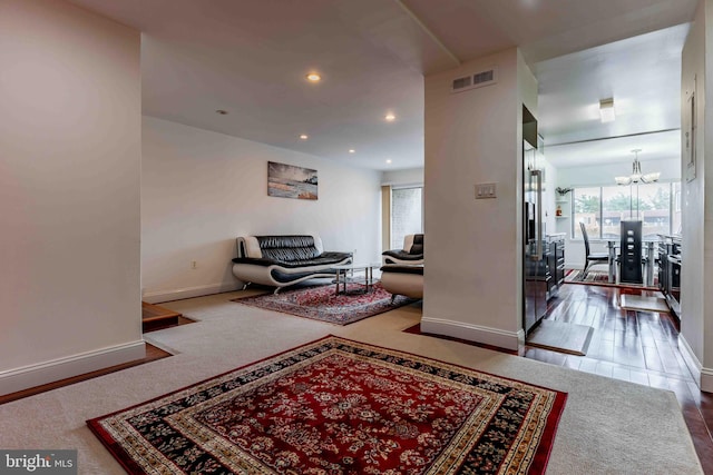 living room with wood-type flooring and a notable chandelier