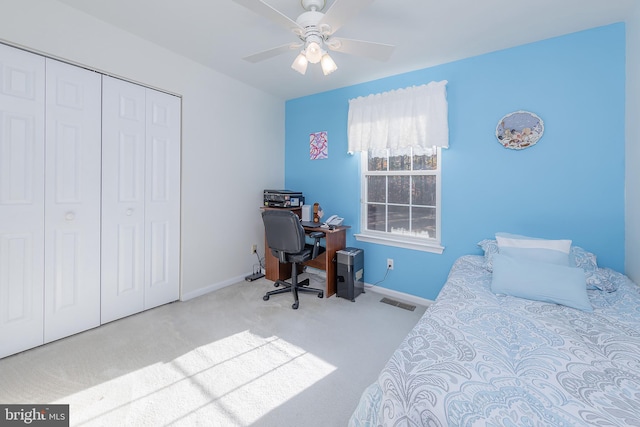 bedroom with light carpet, baseboards, visible vents, and a closet