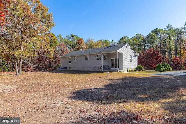 back of house with a yard