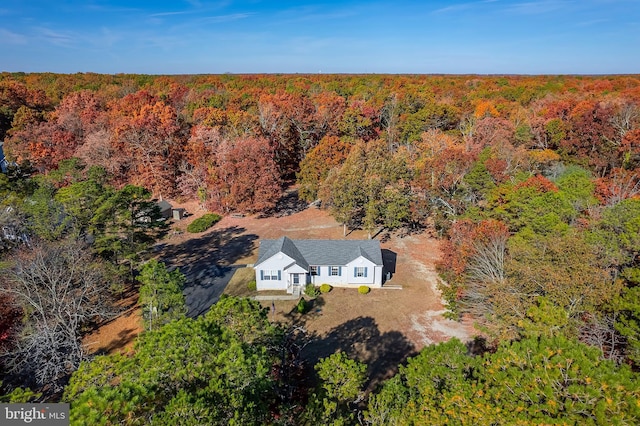 drone / aerial view featuring a forest view