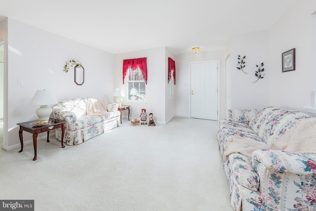 carpeted living area featuring baseboards