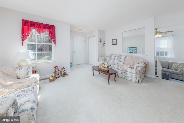 living area featuring carpet and baseboards