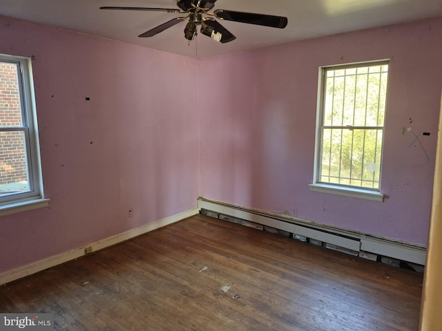 unfurnished room with ceiling fan, a baseboard heating unit, and dark hardwood / wood-style flooring