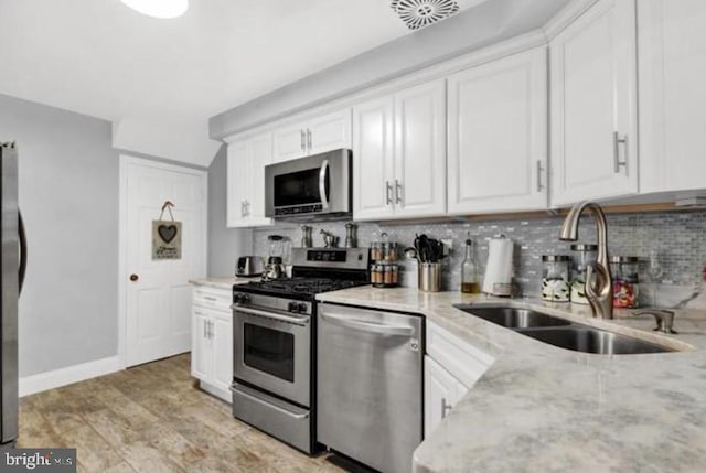 kitchen featuring white cabinetry, sink, and appliances with stainless steel finishes