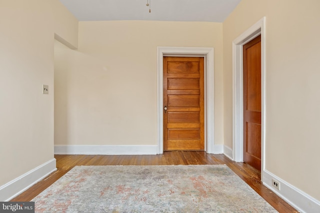 unfurnished room with hardwood / wood-style floors