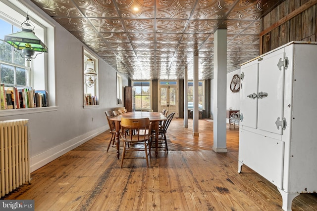 dining room featuring hardwood / wood-style flooring and radiator