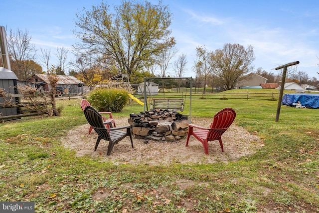 view of yard with a playground and a fire pit