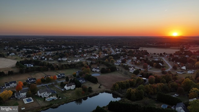 aerial view at dusk with a water view