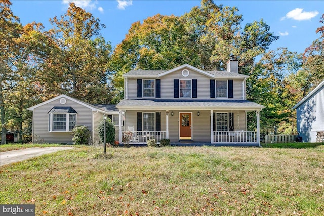 view of front of house featuring a front yard and covered porch