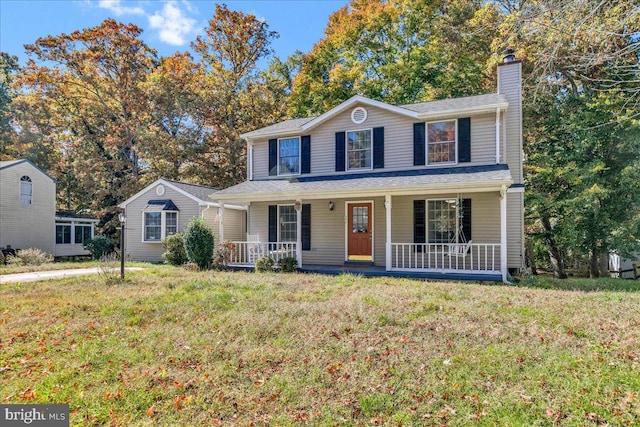 view of front of home with covered porch and a front yard