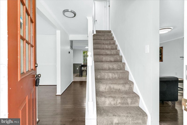 interior space with ornamental molding and hardwood / wood-style flooring