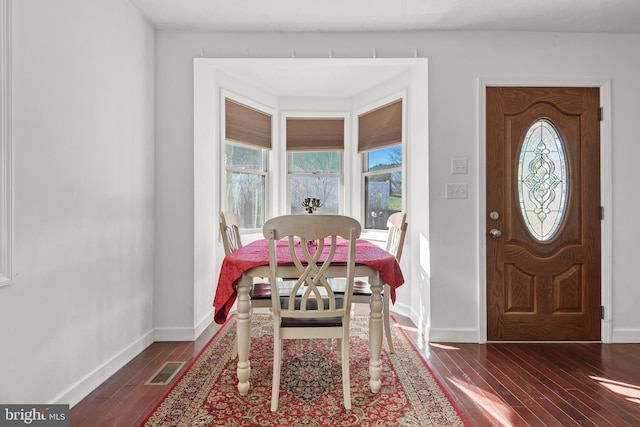 foyer with dark hardwood / wood-style flooring and plenty of natural light