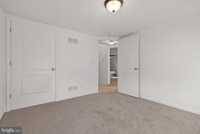 unfurnished bedroom featuring light colored carpet