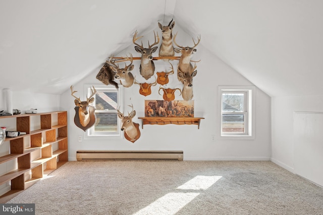 additional living space featuring carpet flooring, lofted ceiling, and a baseboard heating unit