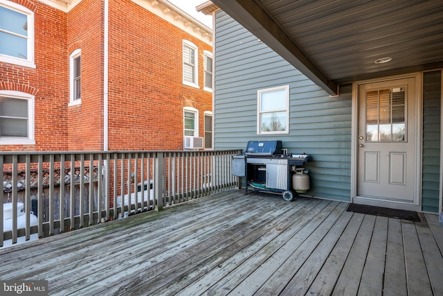 wooden terrace featuring cooling unit and grilling area