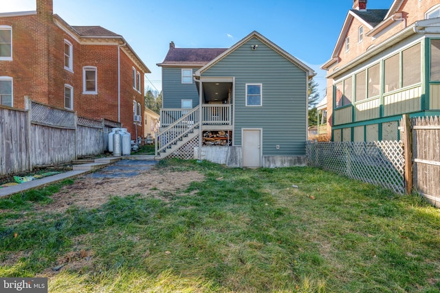 rear view of house with a lawn