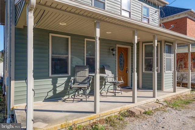 view of exterior entry featuring covered porch