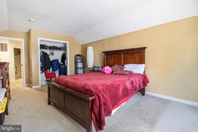 carpeted bedroom with vaulted ceiling and a closet