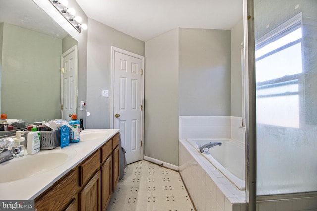 bathroom with tiled bath and vanity