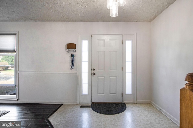 entrance foyer with a textured ceiling