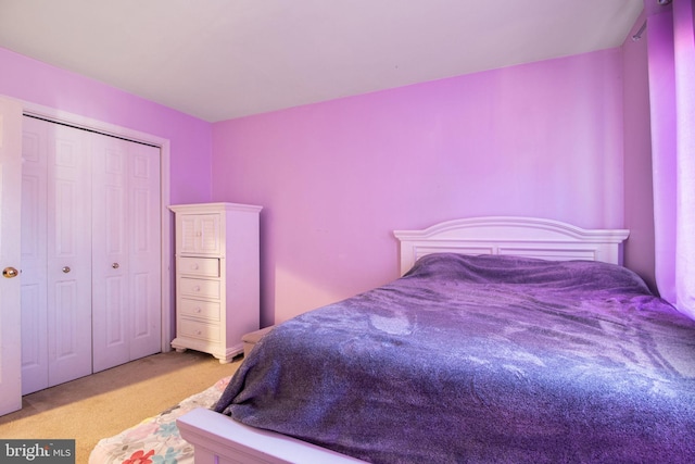 bedroom with light colored carpet and a closet