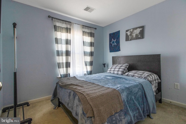 bedroom featuring light carpet