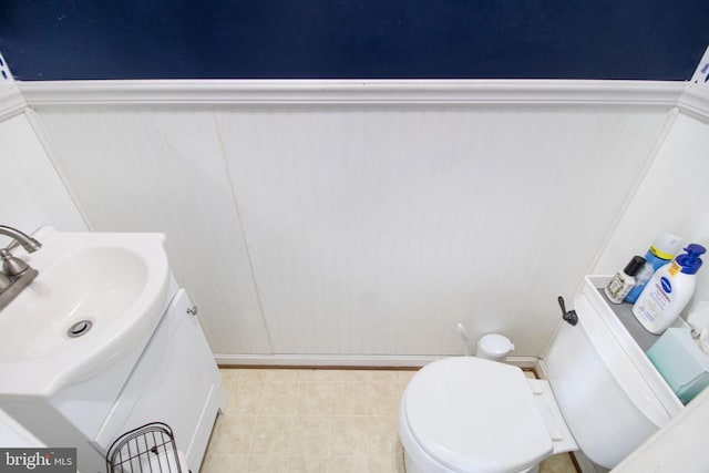 bathroom with tile patterned floors, vanity, and toilet