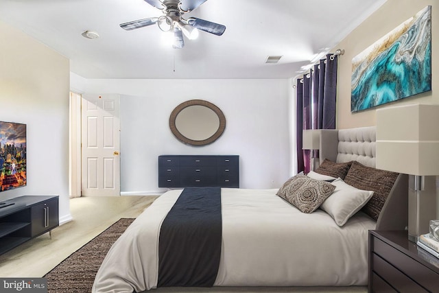 bedroom featuring light colored carpet and ceiling fan