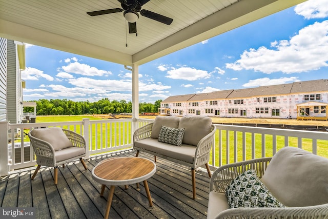 wooden deck featuring an outdoor hangout area, a yard, and ceiling fan