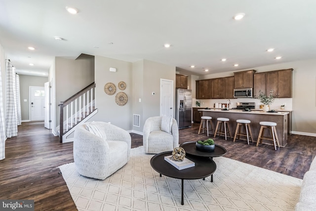 living room with sink and light hardwood / wood-style flooring